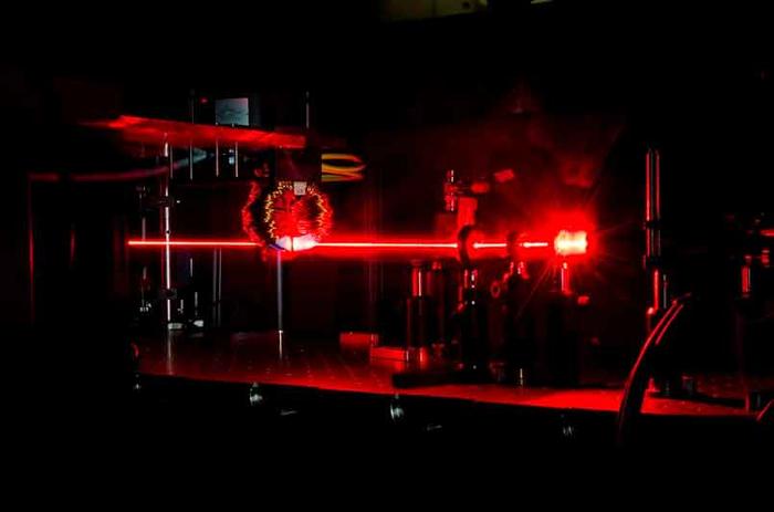 A beam of femtosecond laser pulses excites ultafast  processes in a magnetic material.